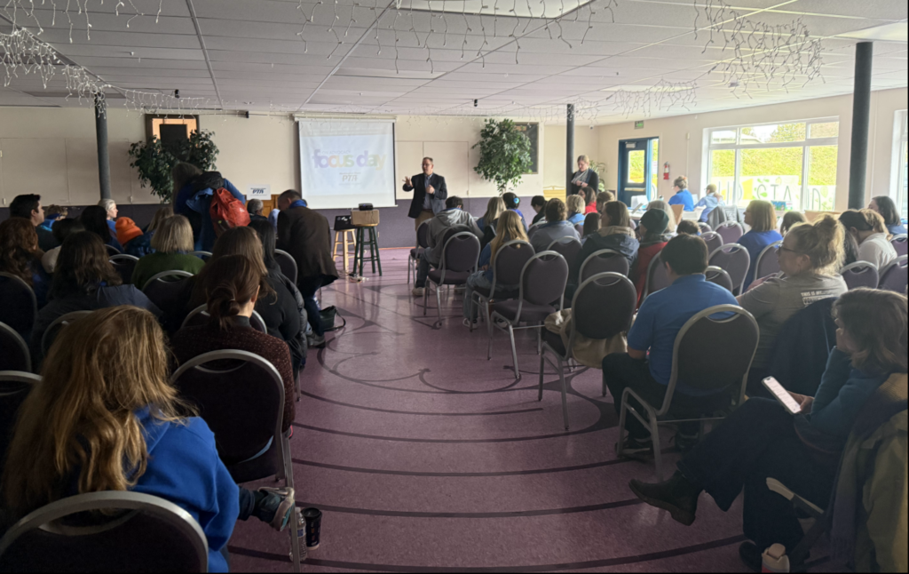 Washington State Superintendent of Public Instruction Chris Reykdal gestures while speaking at the front of a conference room to an audience at Washington State PTA Focus on Advocacy Day, Feb. 17, 2025